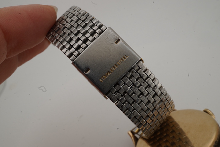 A gentleman's late 1940's 9ct gold Omega manual wind wrist watch, with baton and quarterly Arabic numerals and subsidiary seconds, movement c.265, case diameter 33mm, no logo on winding crown, on an associated stainless